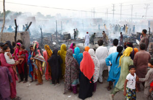 Firefighters struggling to extinguish fire erupted in makeshift huts at Qasimabad.
