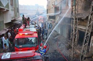 Doctors giving treatment to people at Civil Hospital who sustain burn injuries after cylinder explosion at Peratabad.