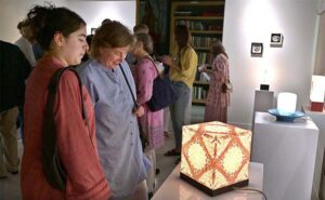 Visitors keenly viewing Paper Artworks – Light Sculptures “In Praise of Shadows” works by Aline Dalgleish at Khaas Art Gallery.