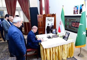 Prime Minister Muhammad Shehbaz Sharif recording his message for late Iranian President Dr. Ibrahim Raisi in the condolence book during his visit to Iranian Embassy.