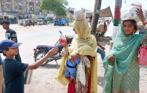 Volunteers giving Juice to People at road side to get relief during extreme hot weather in the city.