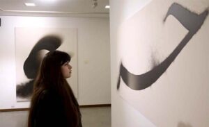 Visitors keenly viewing art work during an exhibition featuring a joint creative interpretation of Iqbal’s Urdu and Persian poetry “…tar-e-harir-e do rang” by artists Shah Abdullah Alamee and Amna Manzoor at Tanzara Art Gallery.