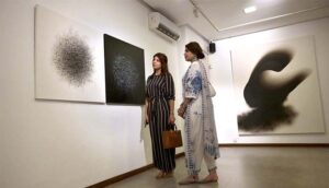 Visitors keenly viewing art work during an exhibition featuring a joint creative interpretation of Iqbal’s Urdu and Persian poetry “…tar-e-harir-e do rang” by artists Shah Abdullah Alamee and Amna Manzoor at Tanzara Art Gallery.