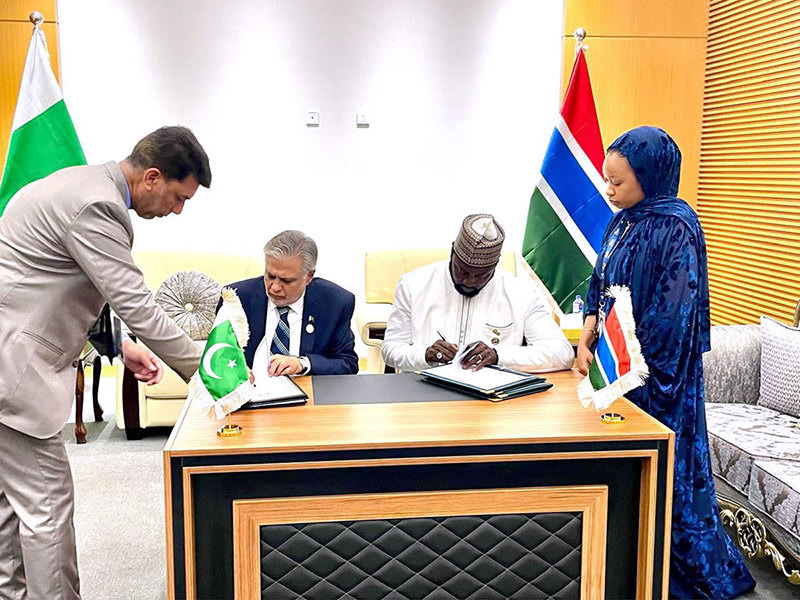 Deputy Prime Minister and Foreign Minister Senator Mohammad Ishaq Dar and Gambian Minister of Foreign Affairs, International Cooperation and Gambians Abroad, Dr. Mamadou Tangara signing MoU on Bilateral Political Consultations on the sidelines of the 15th Islamic Summit, in Banjul