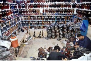 A cobbler preparing traditional shoes (Peshawari Chappal) at his workplace in Provincial Capital.