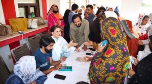 Chairperson Benazir Income Support Programme Mrs. Rubina Khalid, under her supervision, witnessing the payment process to an elderly woman beneficiary at a payment campsite.