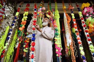 A vendor displaying sacrificial animal decoration items to attract the customers at Ring Road Cattle Market.