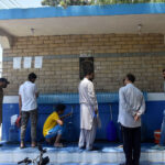 People are filling their pots with clean water at the local water filter plant in Federal Capital