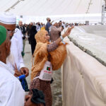 Pilgrims are pelting stone at Satan as a part of the Hajj procession