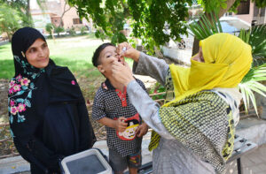 Lady Health worker administering polio drops to a child during anti polio campaign "Polio Free Pakistan" in the city.