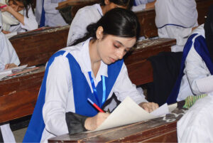 Students solving question paper during annual examination of HSSC (part-I) 2024 at Degree Girls Collage at Latifabad.