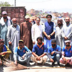 Chairman Rawalpindi Waste Management Company, Saqib Rafeeque in a group photo with the workers during the waste deposit operation on the eve of Eid ul Adha
