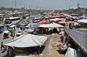 The scene at Pirwadhai is one of chaos and congestion, exacerbated by handcarts blatantly encroaching upon the thoroughfare, disrupting the flow of traffic