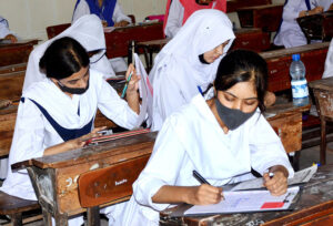 Students solving question paper during annual examination of HSSC (part-I) 2024 at Degree Girls Collage at Latifabad.