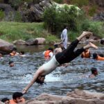 In Angoori,A youngster seeks relief from the intense heat by diving and splashing into the cool waters on a scorching day
