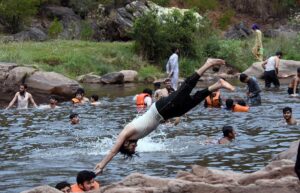In Angoori,A youngster seeks relief from the intense heat by diving and splashing into the cool waters on a scorching day
