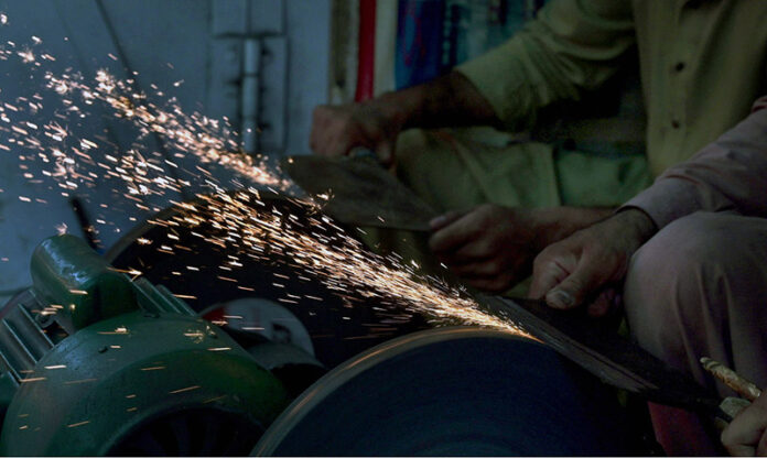 Blacksmiths are busy in sharpening knives to be used for slaughtering sacrificial animals ahead of Eid-ul Azha at Purana Qila