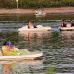 People enjoying mechanized swing at Gulshan-e-Iqbal Park