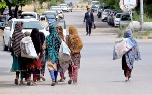 Gypsy girls on the way for searching valuable items from garbage in the Federal Capital.
