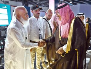 Saudi Minister of Information Salman Al-Dosari shaking hands with foreign journalists during a visit to the media hub established for Hajj 2024