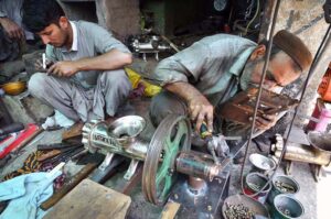 A skilled blacksmith repairs a meat mince machine at his workshop near the Old GTS bus stop, ensuring seamless work for the Eid ul-Adha feasts ahead.