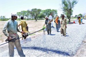 Labourers busy in repairing work of Shekhan Road during development work in the city.