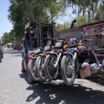 Traffic police's official lifting illegal parked motorbikes with the help of lifter at City Road