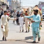 A vendor displaying and selling wooden pieces to be used for cutting meat of sacrificial animals during Eid-ul-Adha