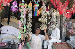 A vendor displaying decorating accessories of sacrificial animals to attract the customer at Fort Road.