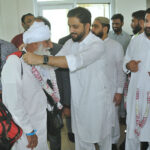 Director Hajj, Rehan Khokhar receiving pilgrims after the first post-Hajj flight landed at Multan Airport