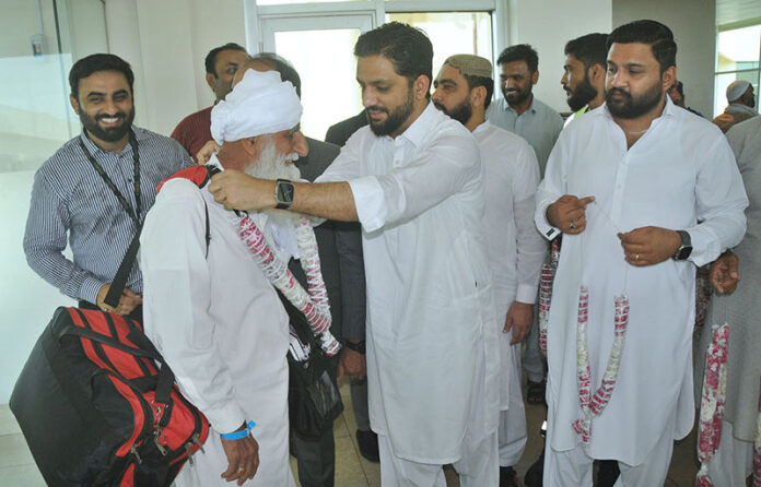 Director Hajj, Rehan Khokhar receiving pilgrims after the first post-Hajj flight landed at Multan Airport