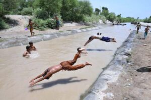 Youngsters jumping and bathing in Khesana Mori Canal to get relief from scorching hot weather in the city.