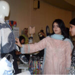 Visitors viewing the displayed items during the Art and Design exhibition