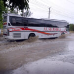 Vehicles passing through stagnant rain water accumulated on road during heavy rain that experienced in Federal Capital