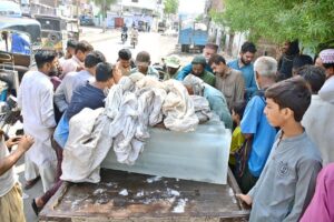 People crowded around ice vendors in the city to purchase ice during the sweltering heat.