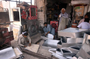 Workers are making room coolers at his Work Place as per increasing demand in summer season.