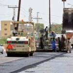 Labourers busy in preparing the new carpeting of kotri area road with help of machine during development work in the city