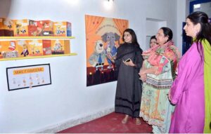 Visitors viewing the displayed paintings and art work during the Art and Design exhibition (Degree Show 2024) at Government College Women University Faisalabad (GCWUF).