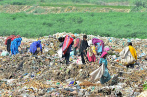 Gypsy people were scavenging for valuable items amidst the garbage in Latifabad.