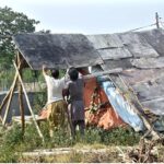 Gypsy men making makeshift home at roadside in the Federal Capital