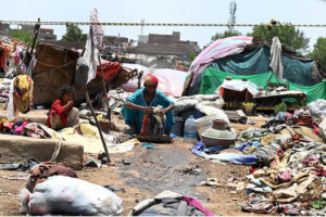Gypsy woman washing the clothes outside her hut at Makki Shah area
