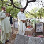 People offering Fateha on the graves of their family members in graveyard on the first day of Eid-ul-Adha