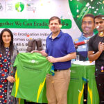 Khizer Afzaal, head of the polio programme in Punjab, presents a campaign shirt to cricketer Bismah Maroof during Pakistan Polio eradication initiative