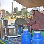 A vendor selling Traditional summer drink (shaker Cola) at his roadside setup