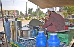 A vendor selling Traditional summer drink (shaker Cola) at his roadside setup