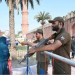 Security official standing high alert outside Badshahi Masjid during Eidul Azha prayers
