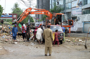 RWMC worker collecting the animal waste from the roadside on the 2nd day of Eid Ul Azha at 6th Road
