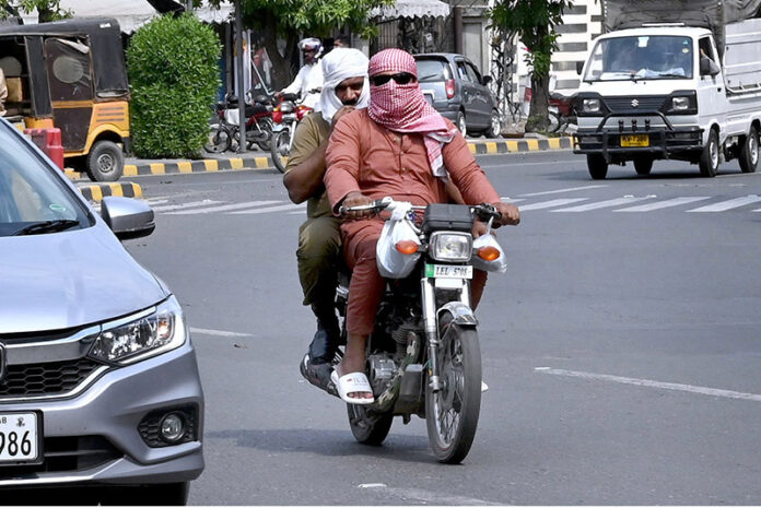 Motorcyclists covered their head and face to protect from scorching heat