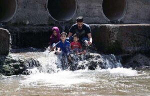 A youngster enjoy playing with child in a local stream to get some relief from hot weather in the Provincial Capital.