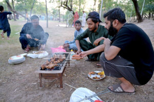 A family enjoying barbeque during their visit to Kanwal Lake on the 3rd day of Eidul Azha holiday in the city